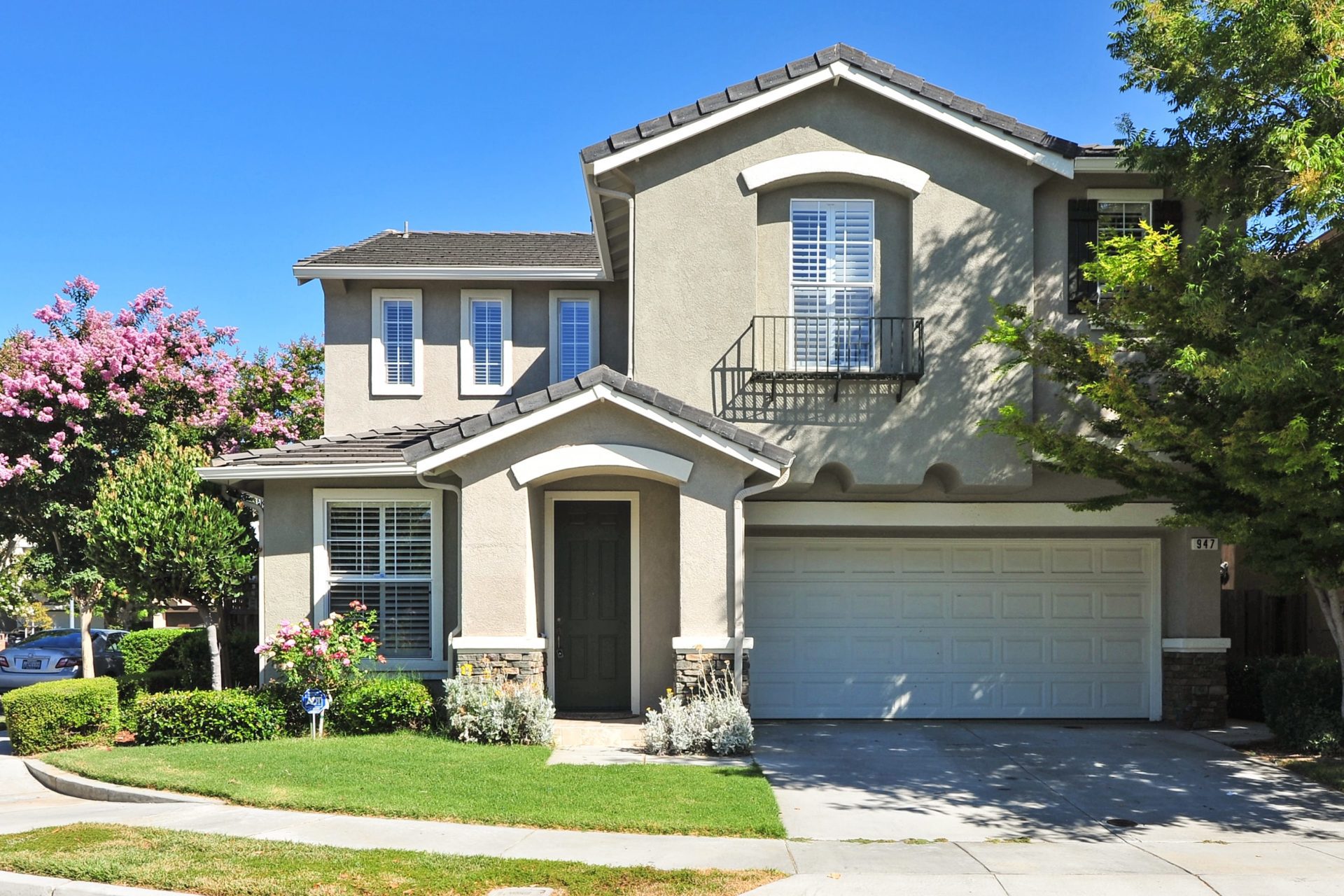 A beige house with a green lawn near where United Properties of West Michigan provides rental properties